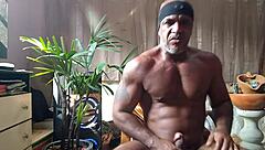 Brazilian bear Kojac solo masturbates his tattooed hairy monster cock