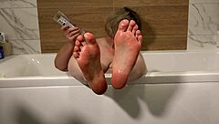 Mature BBW milf offers foot washing in bath with big tits.