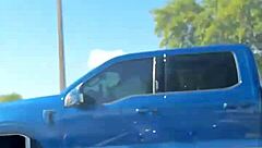 just a girl trying to adjust her sports bra in the gym parking lot before workout