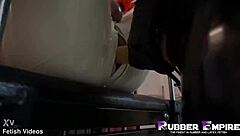 Holy shit, this bold beauty gets gangbanged in rubber latex by femdom slaves with strapons - part 3!