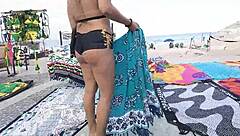 Sexy milf blonde flashes in mini short on Copacabana beach with guys staring