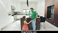 young girl sucking older mans cock behind kitchen counter while woman is busy - orgyfamily