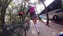 Exhibiting miniskirt upskirt through city streets with pigtails and socks