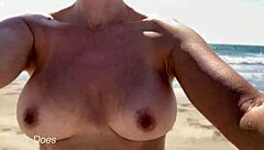 wife enjoys a relaxing walk around the public beach without clothes