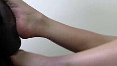 busty blonde gives interracial footjob until toes get covered in jizz