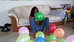 Bold French Ebony Woman Inflates Balloons with Intense Energy and Flair