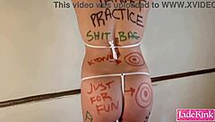 Tied up submissive slut with small tits endures body writing humiliation and maledom punishment