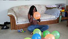 Bold French Ebony Woman Inflates Balloons with Intense Energy and Flair