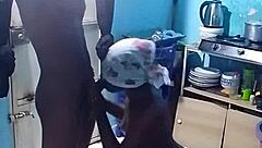 African amateur bends over in kitchen revealing big pussy lips and wet ebony slit