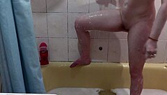 hey check this cute naked girl getting soapy foam all over her wet pussy boobs and ass