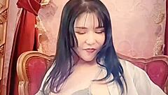 Japanese Milf's Big Tits Spill from Blue Satin Webcam Tease