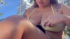 Horny beach exhibitionist flashes big pussy for guys