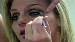 Rubia putita prostitute applies makeup seductively