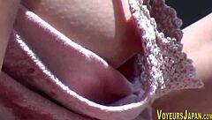 Voyeur peeps asian babe's side boob and small nipples outdoors