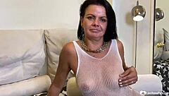 Brunette in fishnets plays with outfit close-up