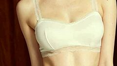 Cute model slips into flowery panties and barefoot lingerie