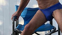 stretching deep in blue briefs on chair october workout thrill