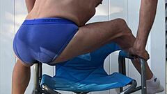 stretching deep in blue briefs on chair october workout thrill