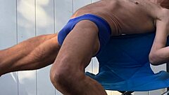 stretching deep in blue briefs on chair october workout thrill