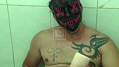 Masked tattooed stud showers toys to cum