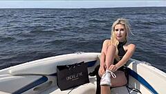 Blonde in lingerie chats with captain on boat