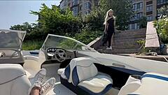 Blonde in lingerie chats with captain on boat