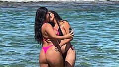 two sexy brazilians enjoying beach kisses outdoors