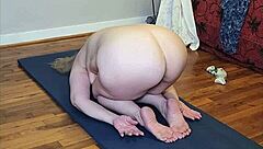 Mature woman flows through naked yoga poses