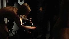 two slaves kiss passionately in silk for their demanding mistress