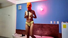 brunette in mask shakes sexy hips naked on halloween hotel bed
