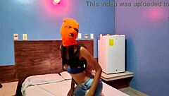 brunette in mask shakes sexy hips naked on halloween hotel bed