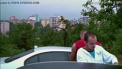 Bent over car window facial in public orgy