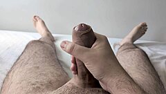 guy jerks big cock solo in bedroom close-up homemade style