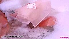gorgeous brunette bathes seductively in steamy solo scene