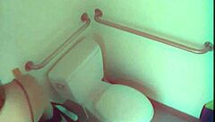 hey, watch this horny slut toy her pussy wildly in that public toilet!