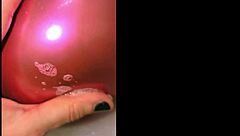 Tattooed babe pops balloons in steamy bath play