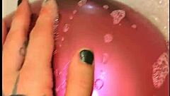Tattooed babe pops balloons in steamy bath play
