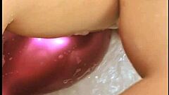Tattooed babe pops balloons in steamy bath play