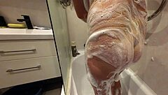 soapy shaved stepsis body glistens in 4k slowmo closeup