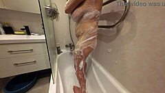 soapy shaved stepsis body glistens in 4k slowmo closeup