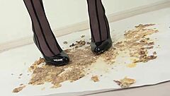 woman in stockings crushes food under her heels slowly