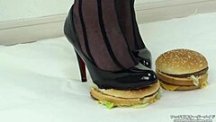 woman in stockings crushes food under her heels slowly