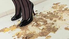 woman in stockings crushes food under her heels slowly