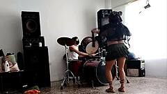 they play drums while she dances and strips her ass