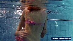 Horny girls strip eachother in the pool