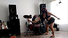 they play drums while she dances and strips her ass