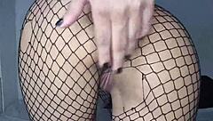 Skinny girl shows off in fishnets and lingerie