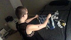Bald girl ignores you while folding laundry