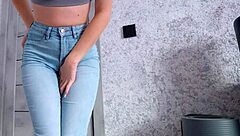 woman shows desperation while peeing in jeans