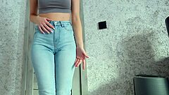 woman shows desperation while peeing in jeans